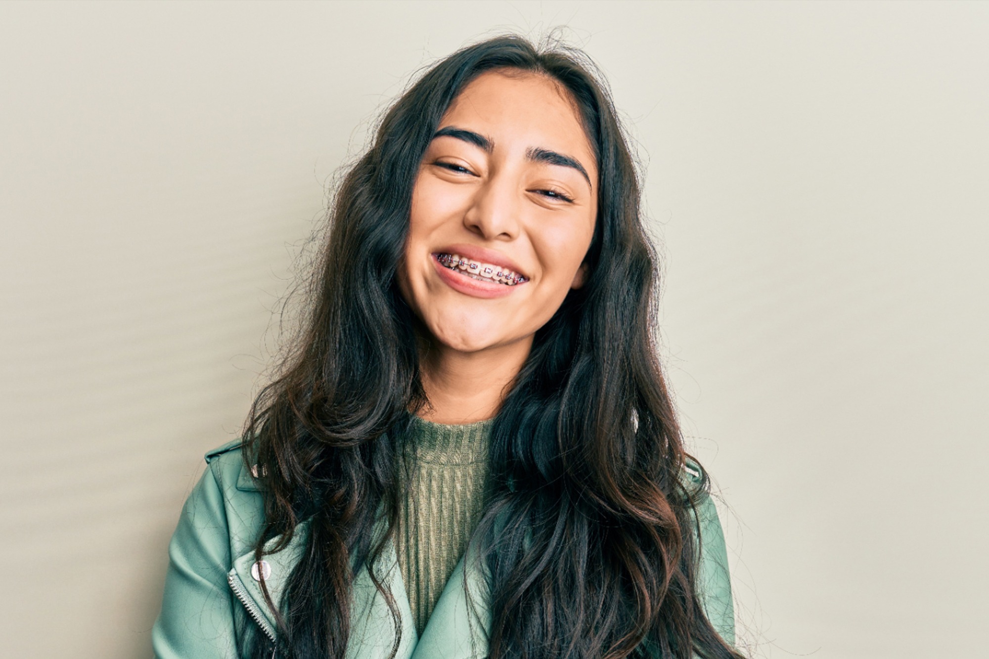 young woman smiling with metal braces